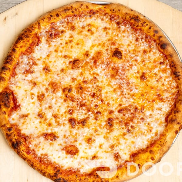 Large cheese pizza with a golden, blistered crust on a wooden board over a wood-grain table.